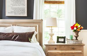 farmhouse bedroom with word art above the bed