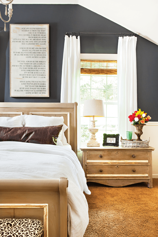 farmhouse bed and nightstand with word art above the bed