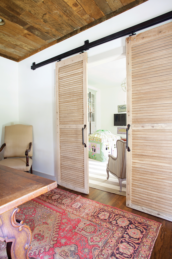 reclaimed wood ceiling in a dining room with shutter barn style doors