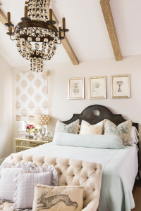 french country bedroom in a beach farmhouse with pastel color palette and zinc headboard