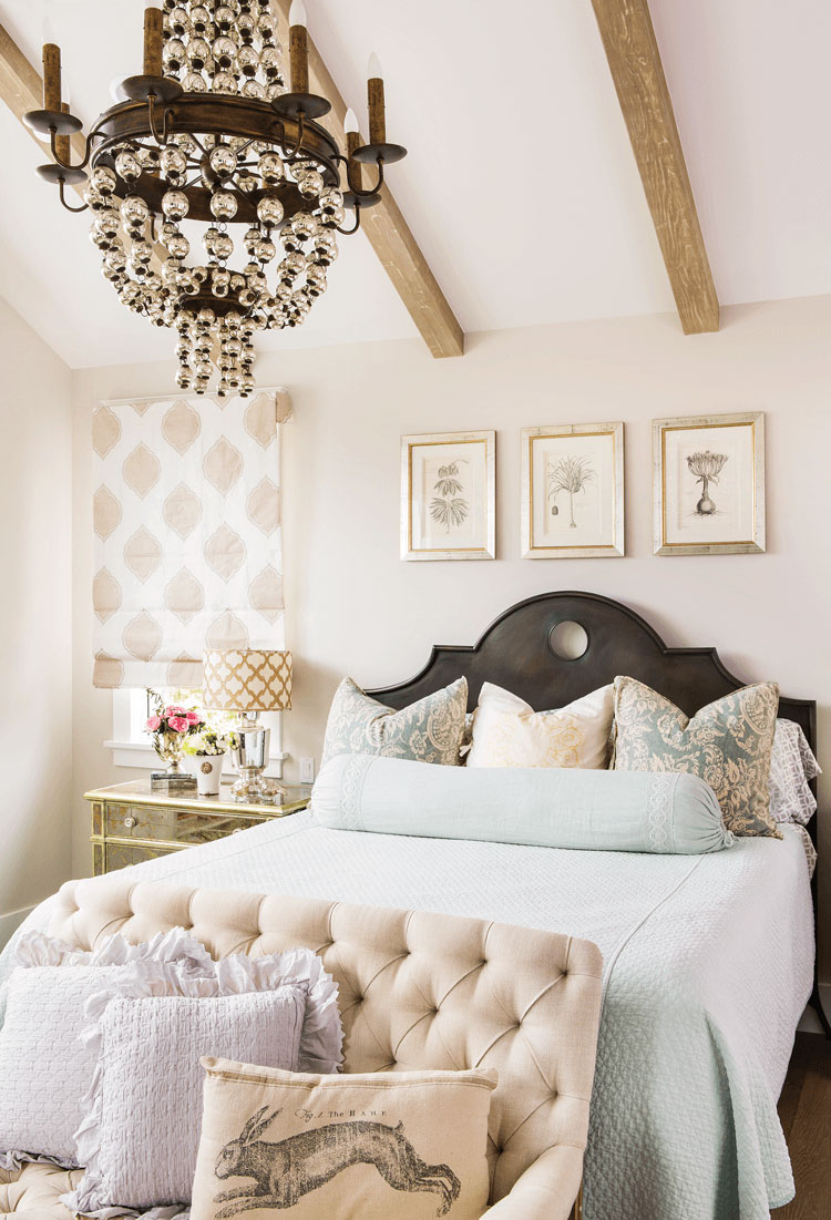 french country bedroom in a beach farmhouse with pastel color palette and zinc headboard