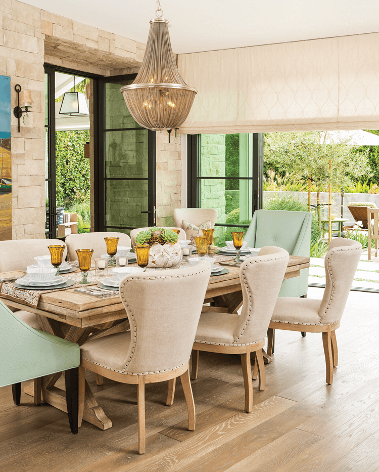 hanging chandelier over rustic modern farmhouse table and chairs 