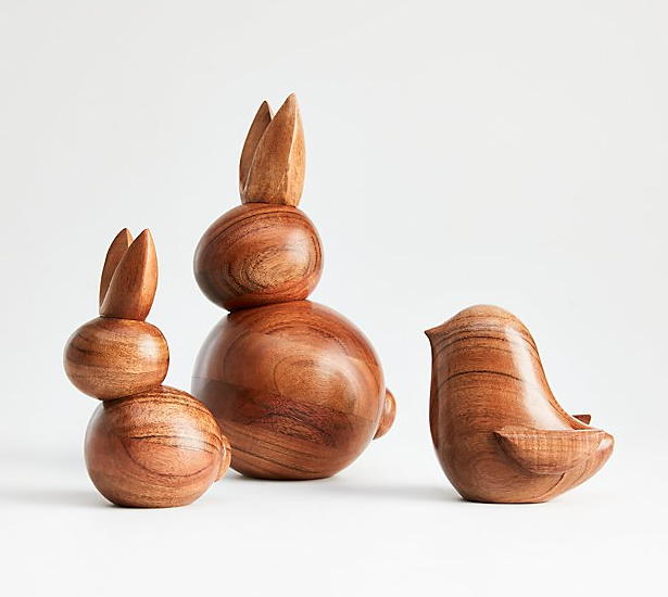 Abstract minimalist carved acacia wooden bunnies and a chick.