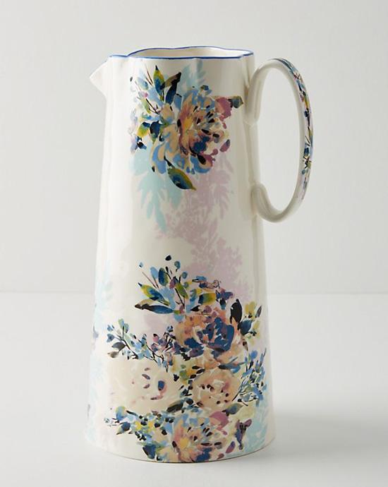 Tall vase with a handle covered in beautiful floral pattern.