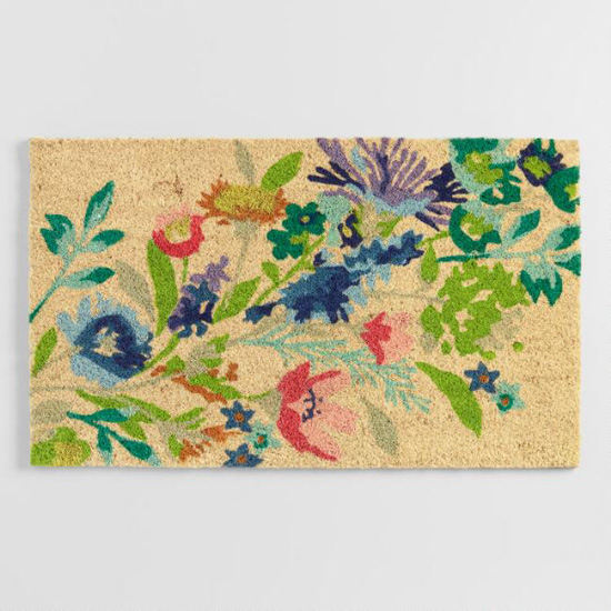 Outdoor mat with spring floral design across it. 