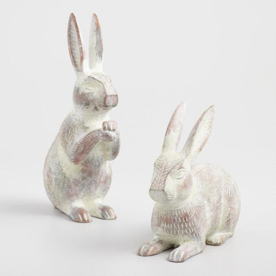 Set of two whitewashed etched bunnies. One on all fours and the other on it's hind legs.