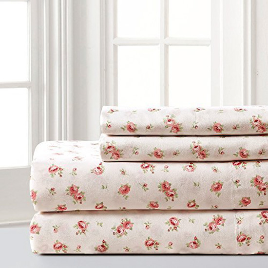 White room with folded stacked pile of sheets with a rose decorative pattern.