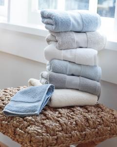 Stack of neatly folded towels in shades of blue and white.