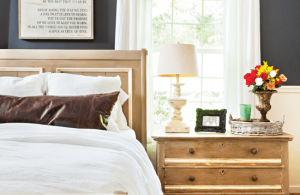 farmhouse bedroom with word art hanging above bed