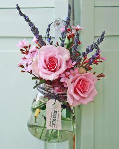 Fresh flower in a mason jar hanging on a crystal knob.