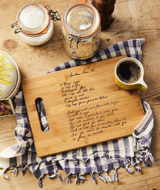 custom made cutting board laying on a gingham hand towel.