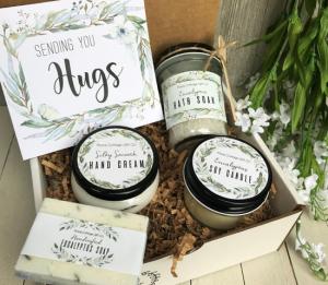 Box filled with raffia and individual containers of home spa essentials.