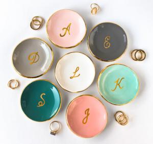 Multi-colored ring dishes with gold rims and gold monogramming in the center