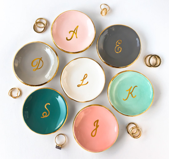 Multi-colored ring dishes with gold rims and gold monogramming in the center