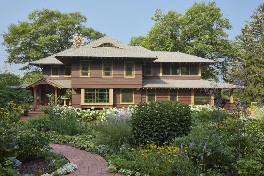 A Craftsman-style home with a natural, meadow-like garden growing in front.