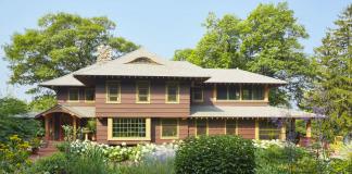 A Craftsman-style home with a natural, meadow-like garden growing in front.