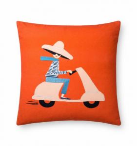 Bright orange throw pillow with a girl riding on a pink scooter.