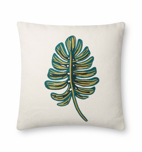 White pillow with a green botanical garden leaf.