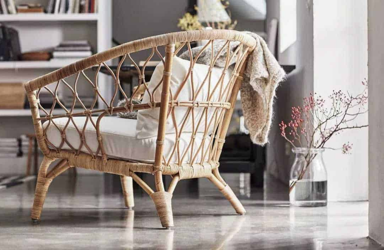 Rattan chair styled in a living room with window light pouring in.