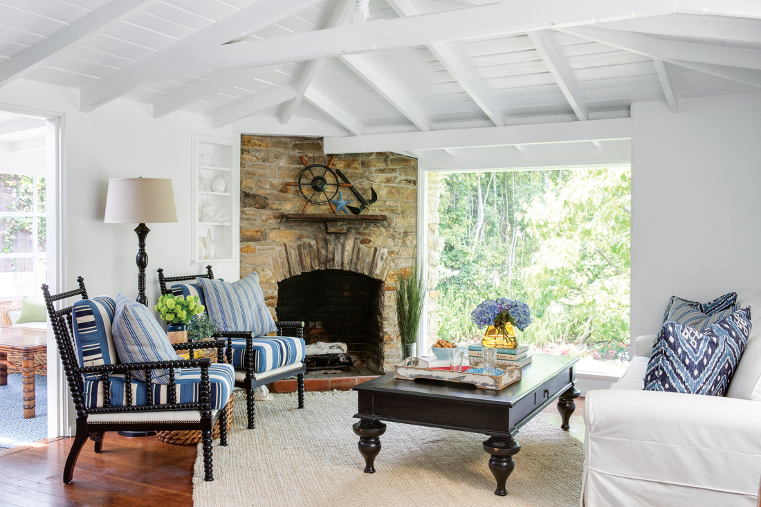 Living area in a vintage beach house with high white vaulted ceilings.