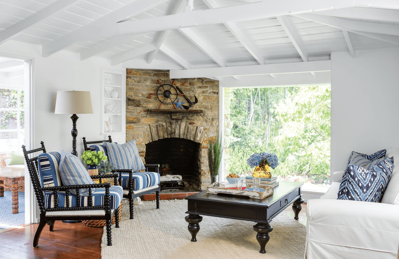 Living area in a vintage beach house with high white vaulted ceilings.