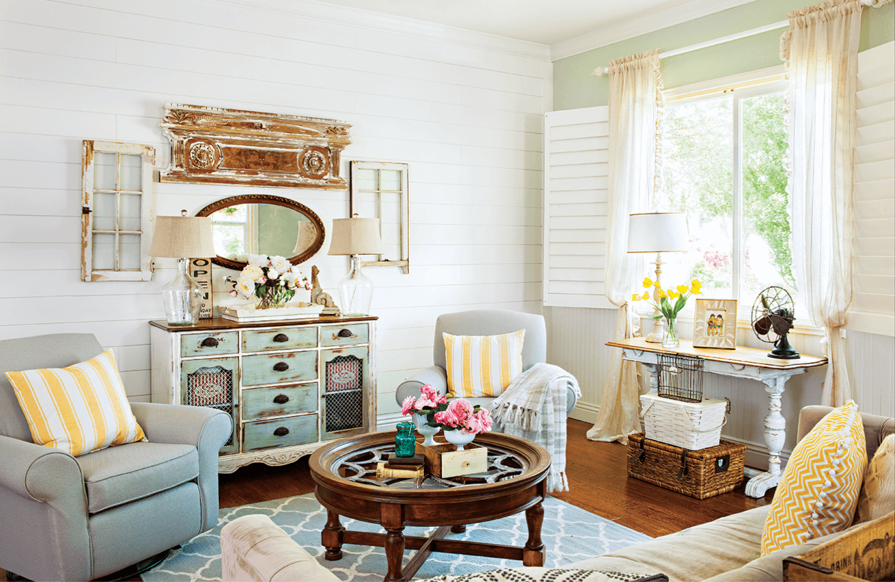 Cozy living room with window light comfy chairs and vintage coffee table.