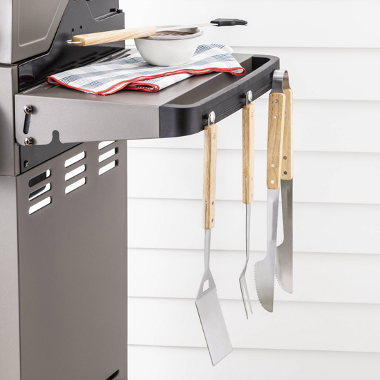 Barbecue tools displayed hanging on the end of a barbecue 