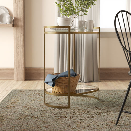 Brass bar cart displaying a basket on the bottom and drink serving ware on top