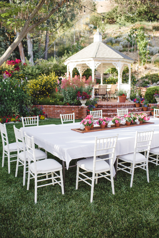 Set outdoor table over looking the yard and white gazebo.