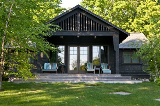 Cottage back patio with blue Adirondack chairs