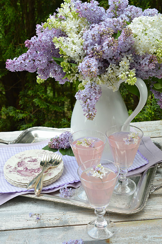 lilacs in a white pitcher on a pretty lavender table setting