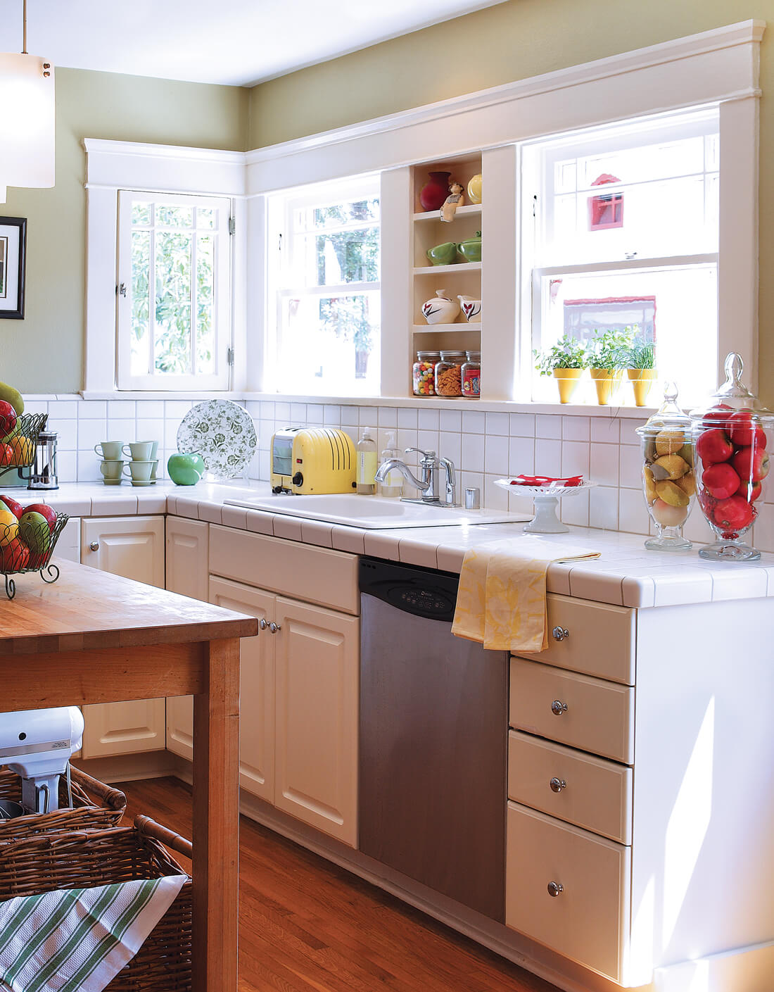 Farmhouse style kitchen with country charm and white square-tiled countertop. 