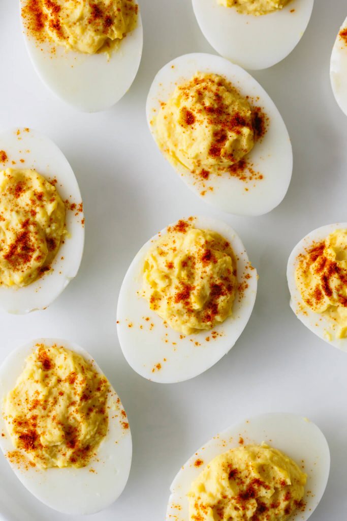 Egg yolks, mayonnaise and spices sit whipped in hard-boiled egg whites