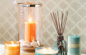 Lit variety of candles and a reed diffuser.