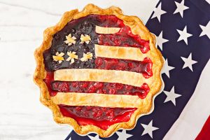 a close up of berry pie with an american flag top crust