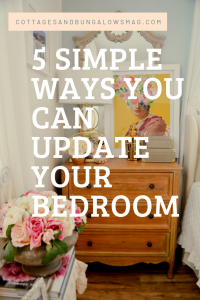 bedroom nightstand with colorful art and flowers