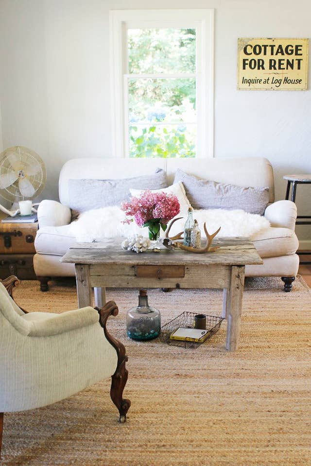a white couch with a worn wooden coffee table