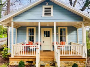 a bright blue cottage with cream and pink accents