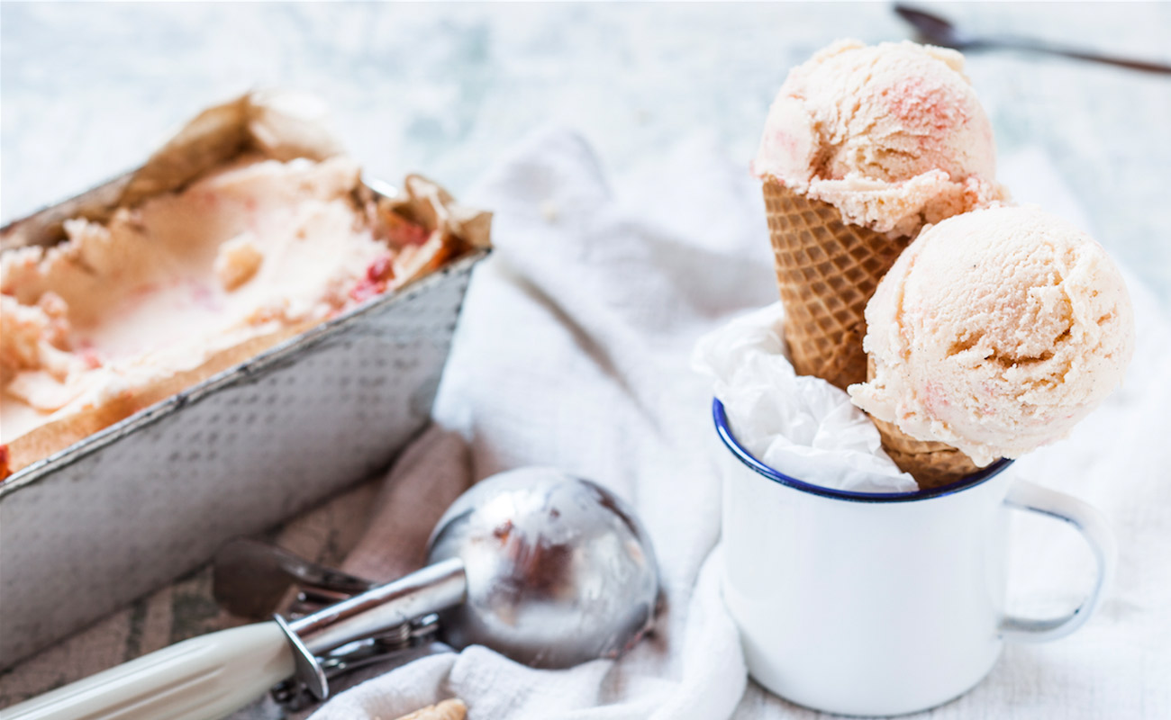 brown ice cream in cones and tin with scooper