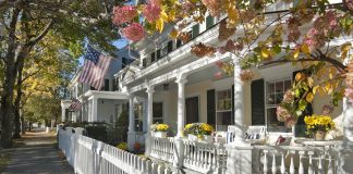 row of small historic homes with white picket fence