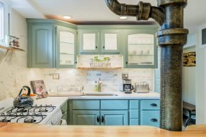 sea foam green kitchen cabinets and white countertops
