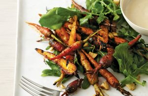 roasted carrots on top of arugula