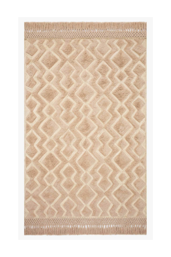 Blush colored area rug with fringed edges from the Magnolia Home Collection. 