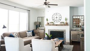 Looking over beige wingback chairs into a rustic living room.