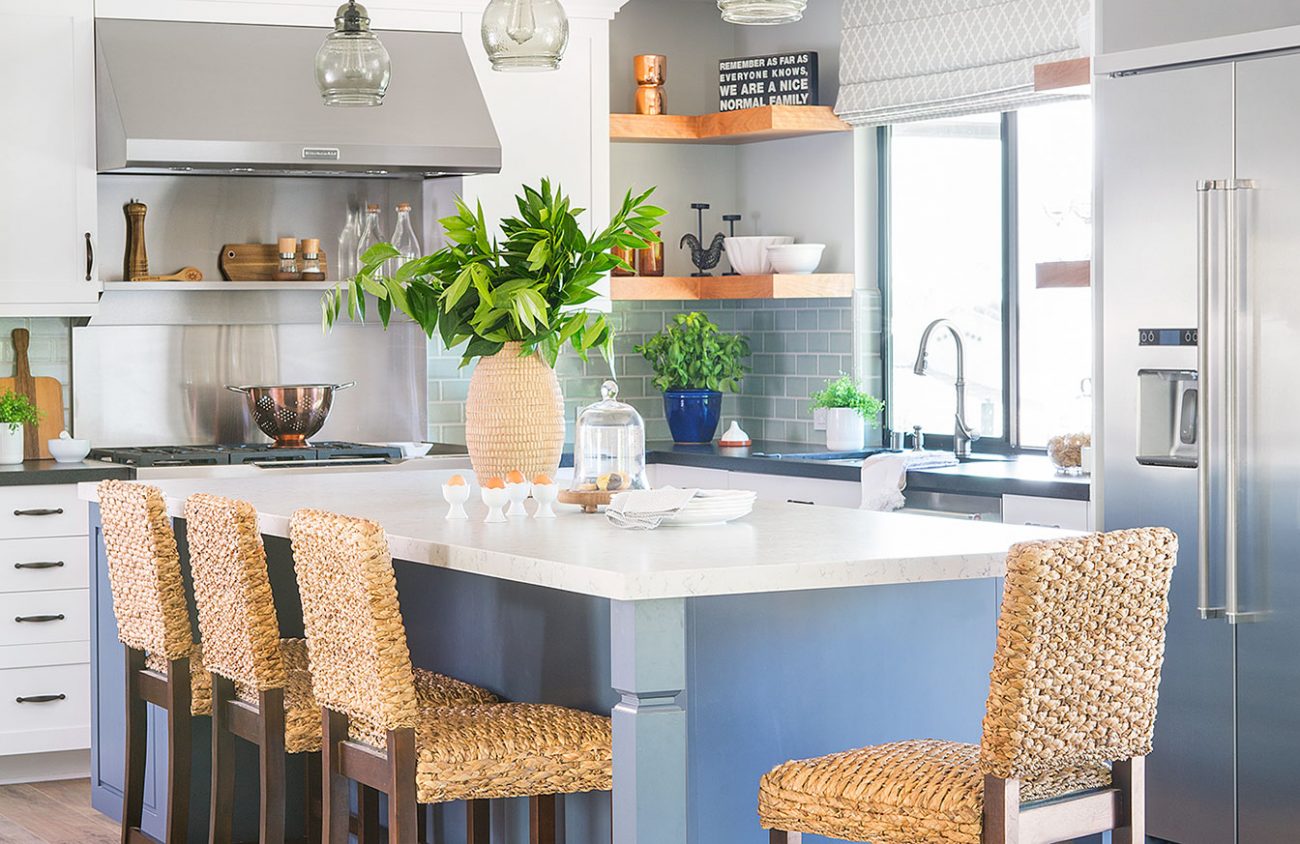 large blue island with crisp white countertop and Routan bar height chairs.