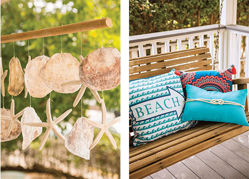 Hanging sand dollar and starfish wind chime and bright throw pillows on the wooden bench swing.