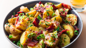 chopped and boiled potatoes in a bowl sprinkled with chives