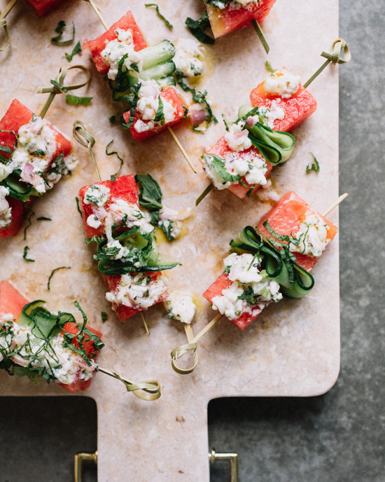 Serving board displaying watermelon and cucumber skewers, ready to be served. 