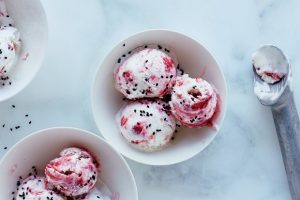 red and white ice cream dotted with black seeds