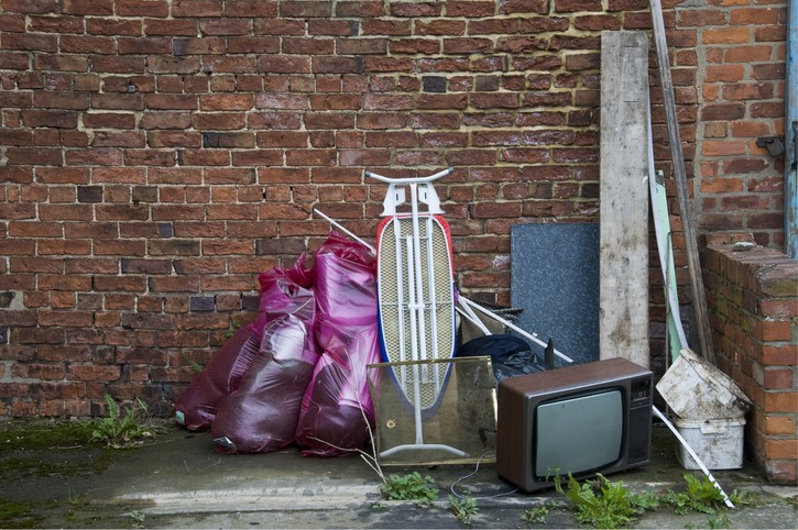 old appliances sitting outside like trash